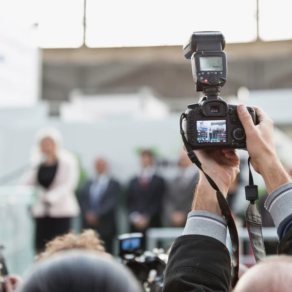 Photographer with camera on conference — Stock Photo, Image