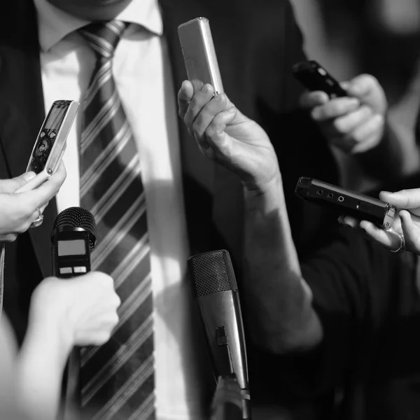 Journalists surrounding politician — Stock Photo, Image