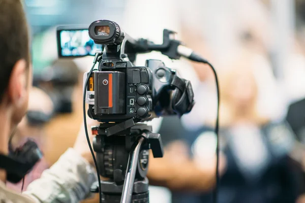 Journalist with Television camera Stock Photo