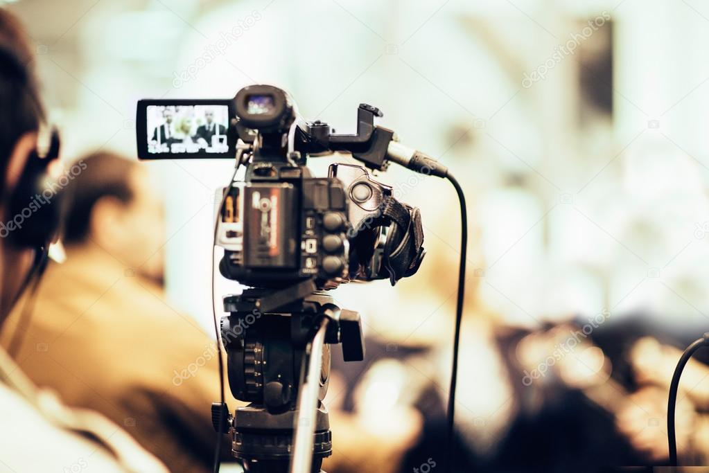 Reporter working with camera — Stock Photo © microgen 115434158