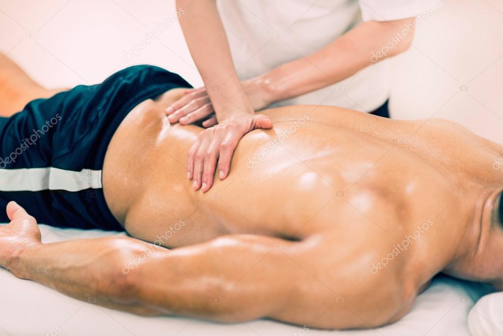 Physical therapist doing massage of lower back