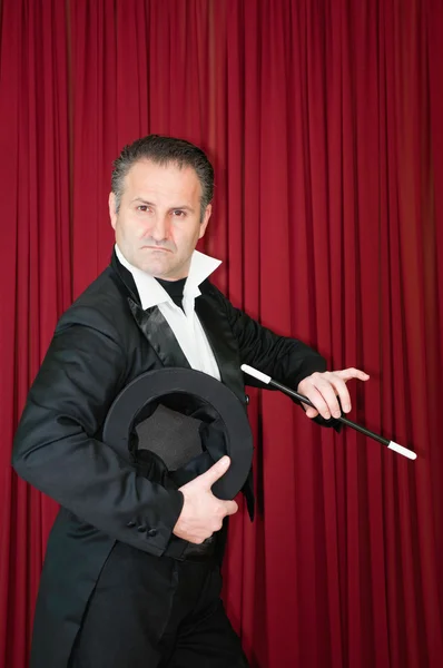 Magician in tuxedo on stage — Stock Photo, Image