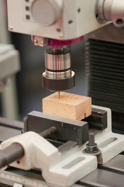 Drill press carving block of wood — Stock Photo, Image