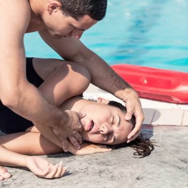 Lifeguard performing medical procedure with victim clipart