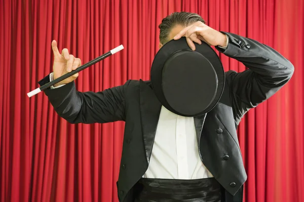 Magician hiding face with hat — Stock Photo, Image