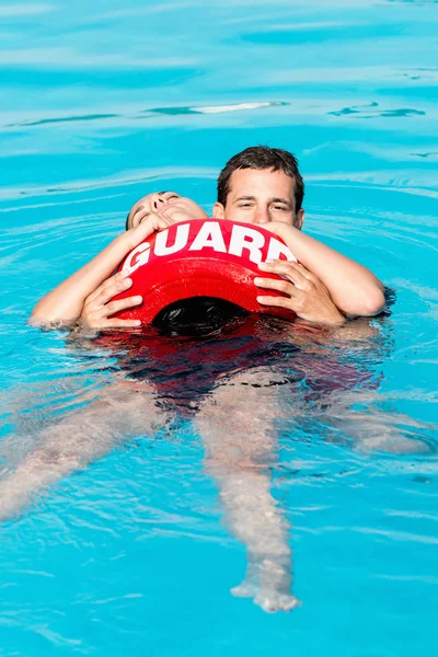 Lifeguard swimming with victim — Stock Photo, Image