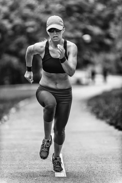 Giovane donna che corre nel parco — Foto Stock