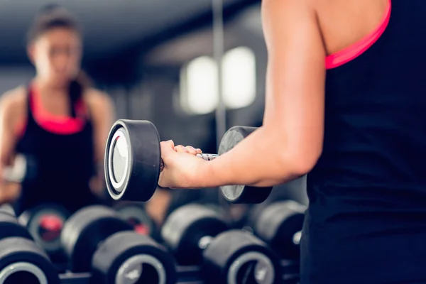 Woman exercising with dumbbell — Stock Photo, Image