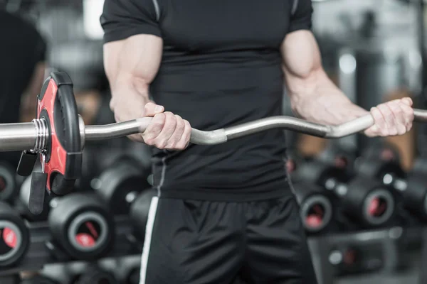 Man working out with barbell — Stock Photo, Image