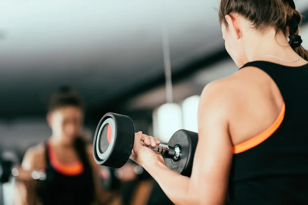 Woman exercising with dumbbell — Stock Photo, Image