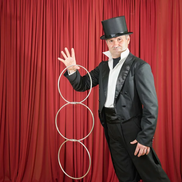 Magician performing trick with rings — Stock Photo, Image