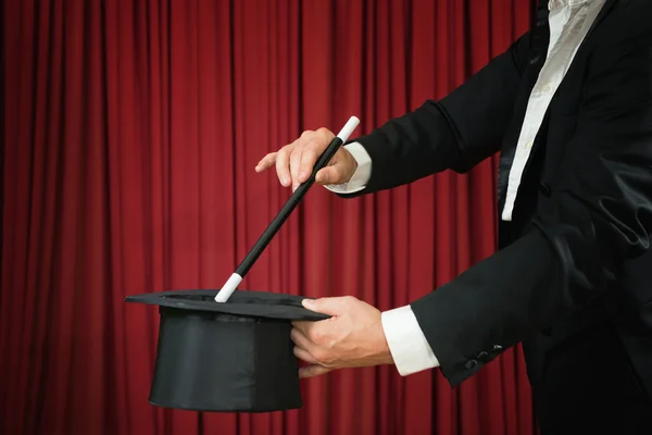 Magician with top hat and magic wand — Stock Photo, Image