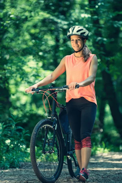 Active lifestyle woman with bicycle — Stock Photo, Image