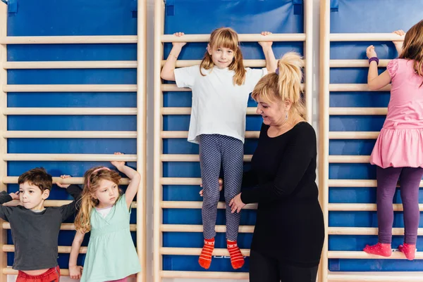 Children climbing wall bars — Stock Photo, Image