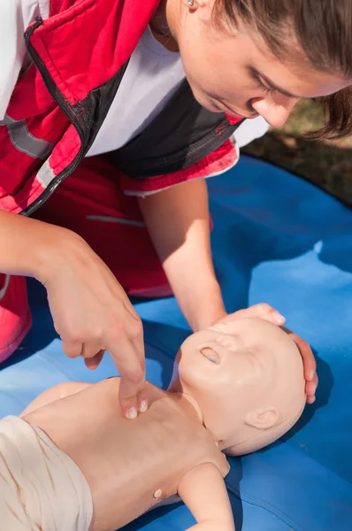 Woman doing infant chest compressions