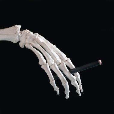 Skeleton hand with cigarette clipart