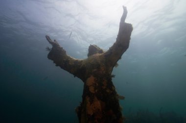 religious underwater statue encrusted in corals clipart