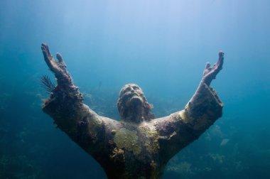 religious underwater statue encrusted in corals clipart