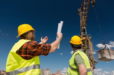 Construction workers over crane  clipart