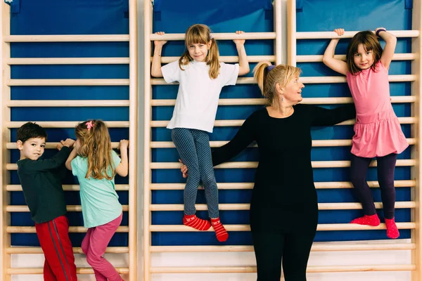 Children climbing wall bars — Stock Photo, Image