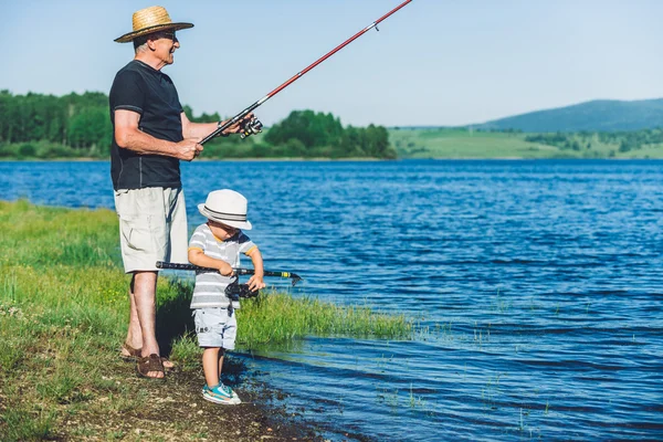 Grandfather with grandson fishing — Stock Photo, Image