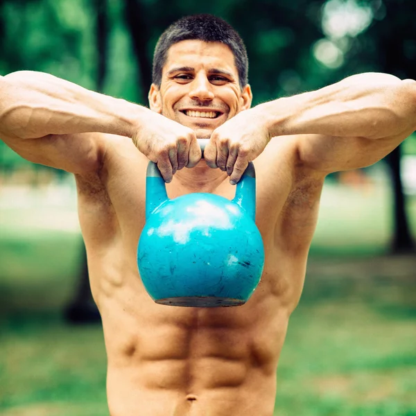 Crossfit athlete with kettle bell — Stock Photo, Image