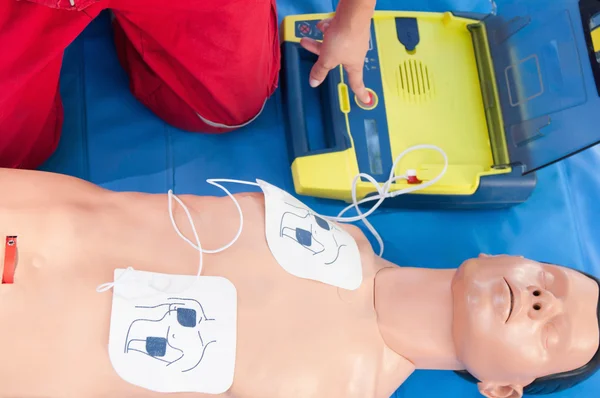 Paramedic activating portable defibrillator — Stock Photo, Image