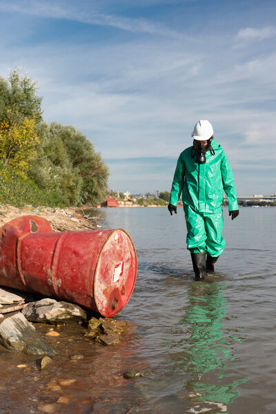 male Environmentalist approaching barrel 