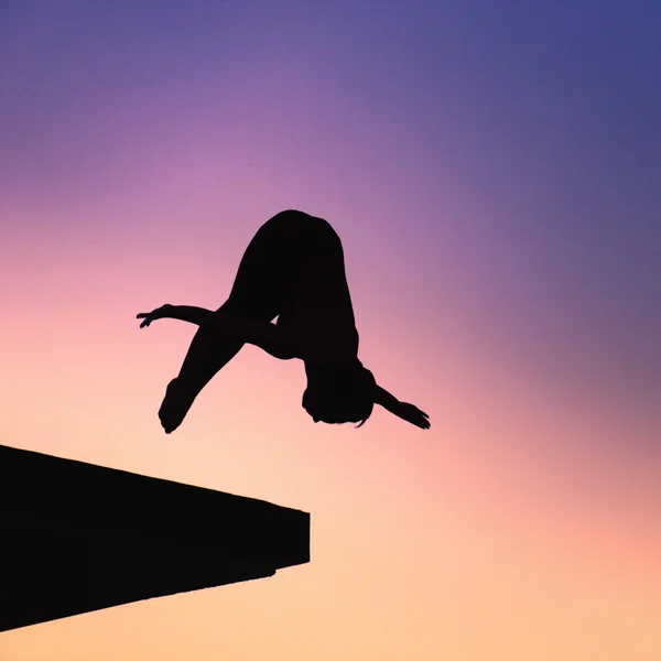 Lady diver diving from platform — Stock Photo, Image