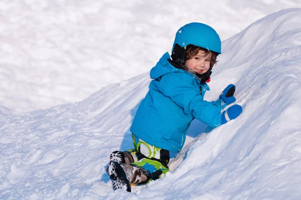 Little boy climbing on snow — Stock Photo, Image