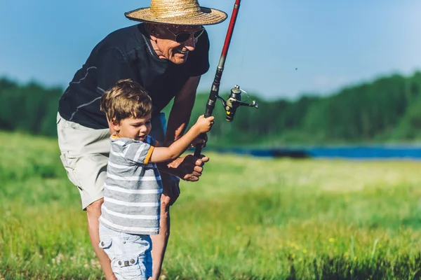 Grandfather with grandson fishing