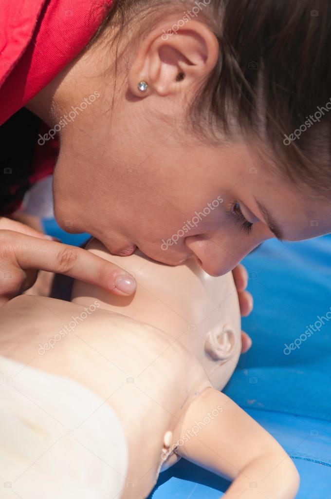 Practitioner gives breath to infant dummy — Stock Photo © microgen
