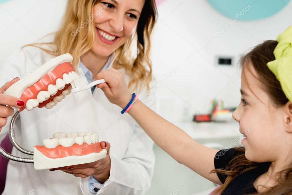 girl at dentist learning about hygiene