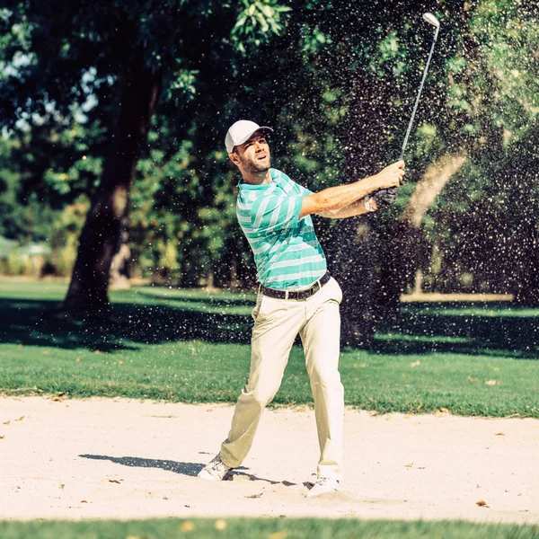 Golfer pulling ball out — Stock Photo, Image