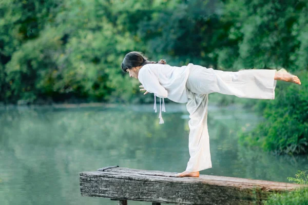 Yoga Lake Young Woman Practicing Warrior Pose Virabhadrasana Iii — стоковое фото