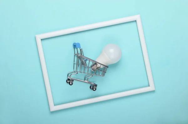 Shopping Trolley Led Light Bulb Blue Background White Frame Studio — Stock Photo, Image