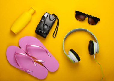 Yaz tatili konsepti, seyahat. Sarı arka planda plaj aksesuarları falan. Stüdyo çekimi. Düz yatıyordu