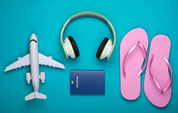 Concepto Viaje Auriculares Estatuilla Avión Pasaporte Chanclas Sobre Fondo Azul — Foto de Stock