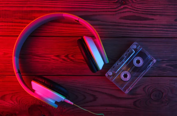 Stereo Headphones Audio Cassette Wooden Background Neon Red Blue Light — Stock Photo, Image