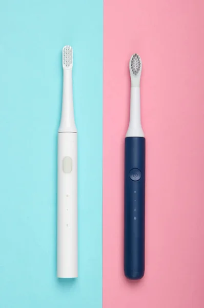 Two Modern Electric Toothbrushes Blue Pink Pastel Background Top View — Stock Photo, Image