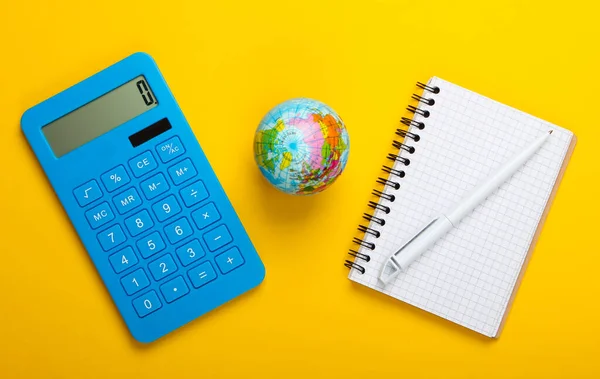 Analysis of world statistics. Globe, calculator, notebook on yellow background. Top view. Flat lay