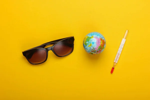 Leżące Tło Lata Wakacje Globus Termometrem Okulary Przeciwsłoneczne Żółtym Tle — Zdjęcie stockowe