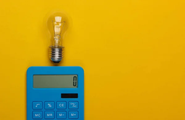 I have an idea! Calculator and light bulb on a yellow background. Energy Savings Concept