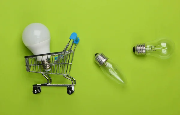 Energy Saving Concept Supermarket Shopping Trolley Light Bulbs Green Background — Stock Photo, Image