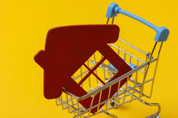 Kupuję Domową Koncepcję Mini Wózek Sklepowy Figurą Domu Żółtym Tle — Zdjęcie stockowe