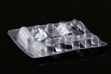 Siyah arka planda buruşuk bir hap kabarcığı.