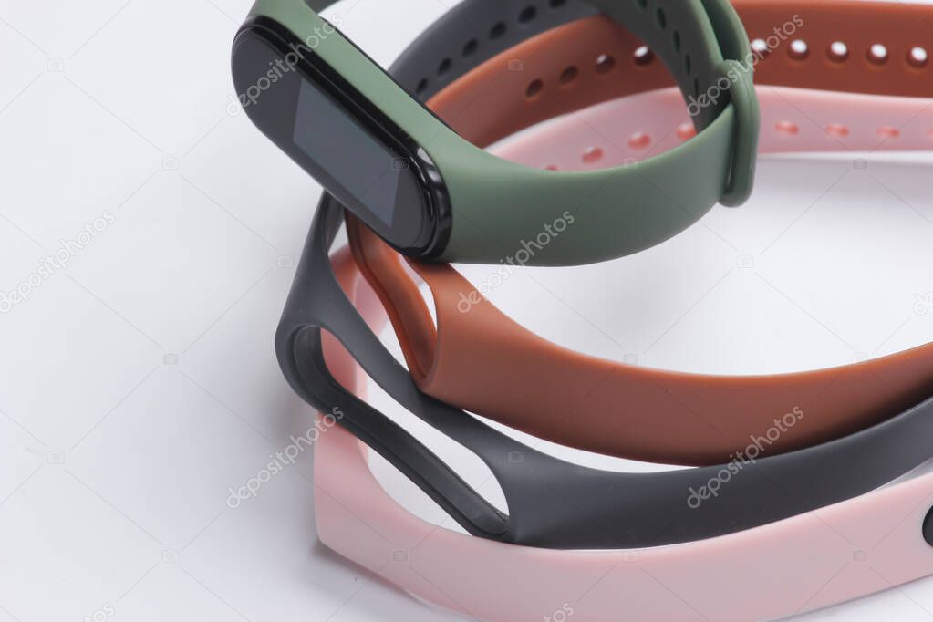 Smart bracelet with interchangeable straps on white background. Modern gadgets