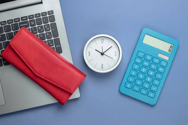 Time to make money. Online business. White clock, laptop, calculator and red wallet on purple background. Top view. Flat lay