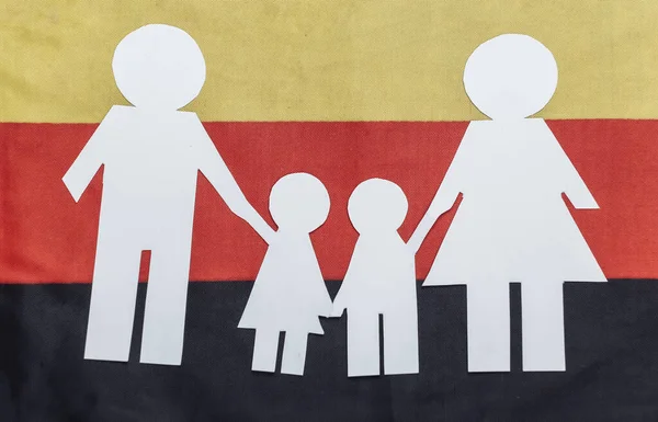 Paper cut family chain on background of Germany flag. Patriotism theme