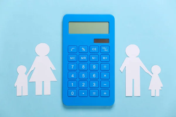 Broken family, divorce. Property division concept. Split paper family, calculator on blue background